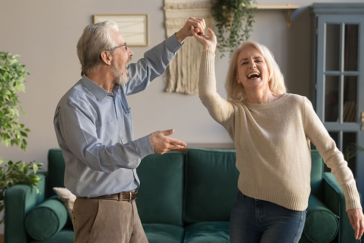 happy couple dancing at home